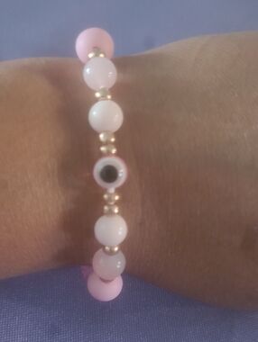 Delicate Pink Beaded Bracelet with Gold Accents and Evil Eye Charm